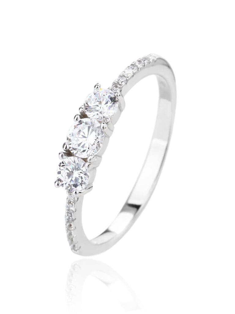 Silver engagement ring with three central and small cubic zirconia stones