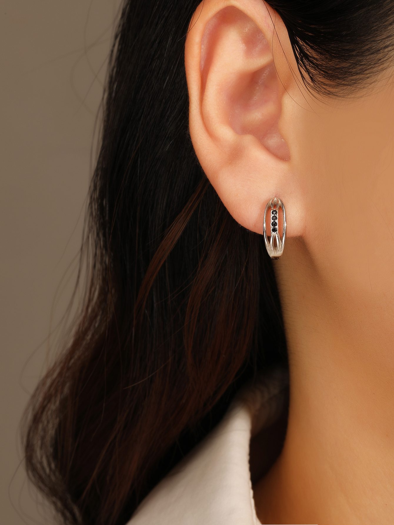 Black stone-studded hoop earrings with a band design and a textured pattern 1