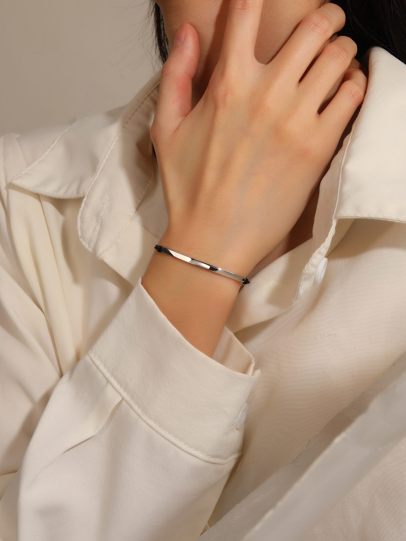 Minimalist silver watch bracelet with black cord 1
