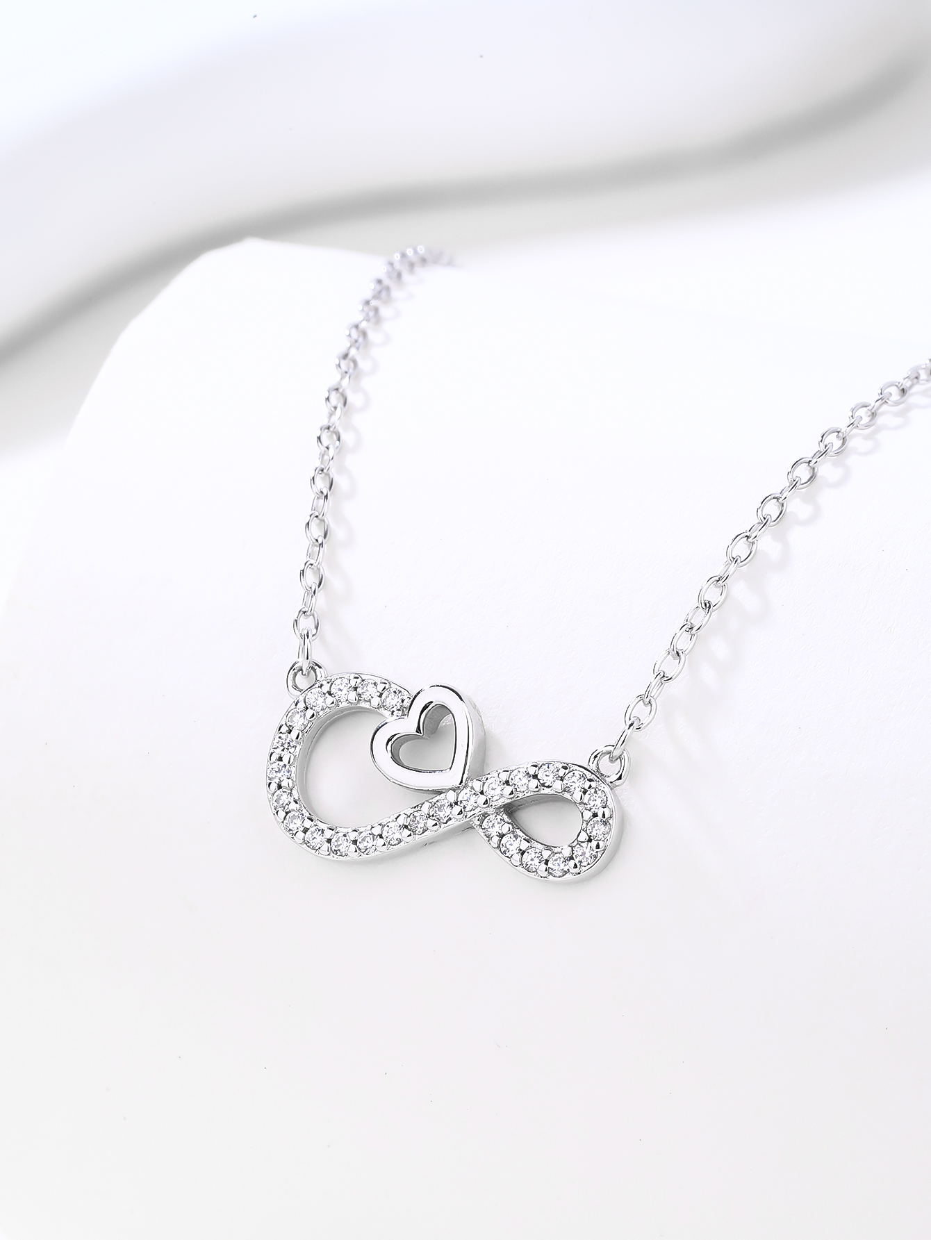 Silver necklace with infinity and heart motifs, set with cubic zirconia and rhodium-plated 3